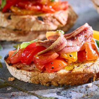 Garlic toast with roasted peppers and anchovies